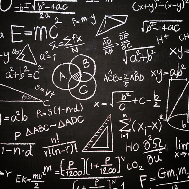 Blackboard inscribed with scientific formulas and calculations in physics