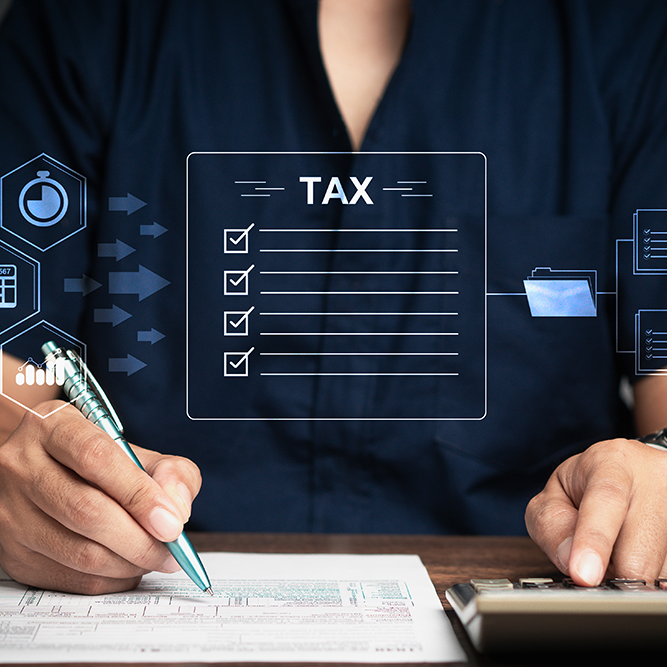 Businessman using a calculator to calculate tax while sitting at the table